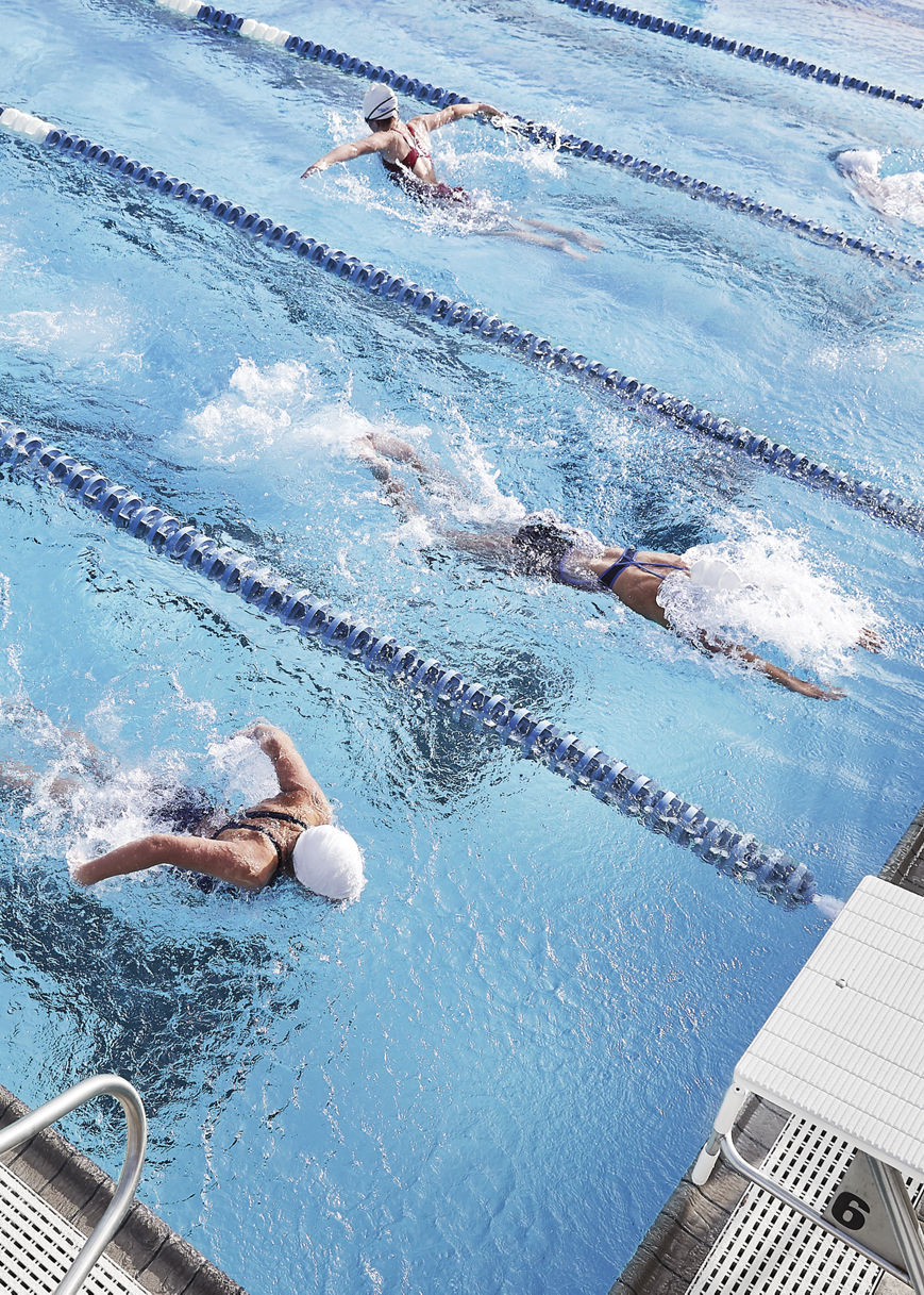 Aerial view of people swimming laps in an outdoor pool at Life Time