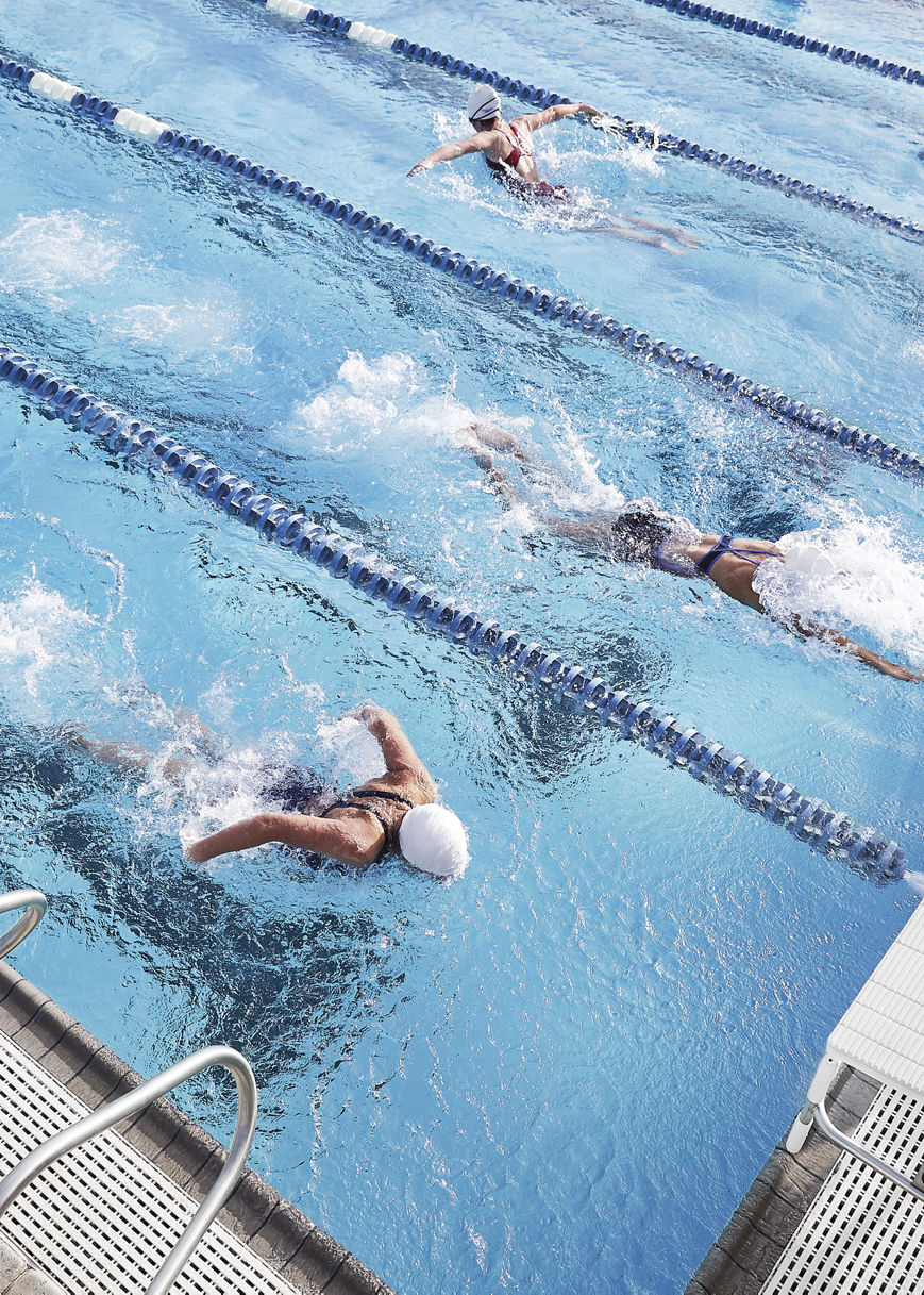 Aerial view of people swimming laps in an outdoor pool at Life Time