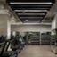 Fitness floor filled with treadmills, dumbbells and kettlebells on racks