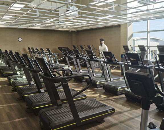 An adult male running on a treadmill