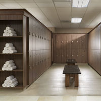 Wooden locker room bay with marble benches and rolled up towels
