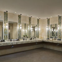 marble tile and glass sink area, with large mirrors