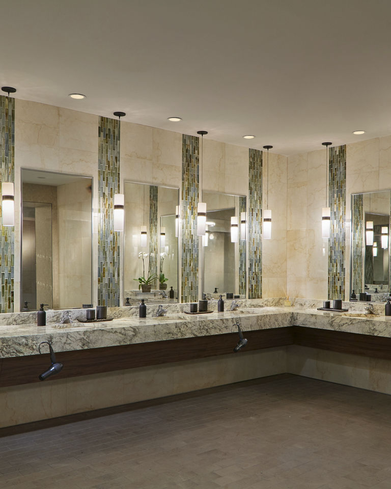marble tile and glass sink area, with large mirrors