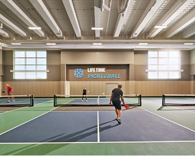 Two adults playing a game of pickleball