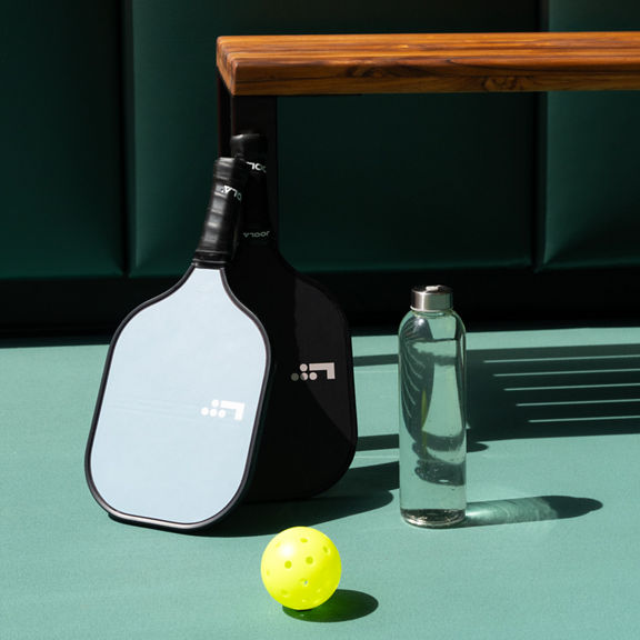 A bench on an indoor Pickleball court at the Life Time Penn 1 club location