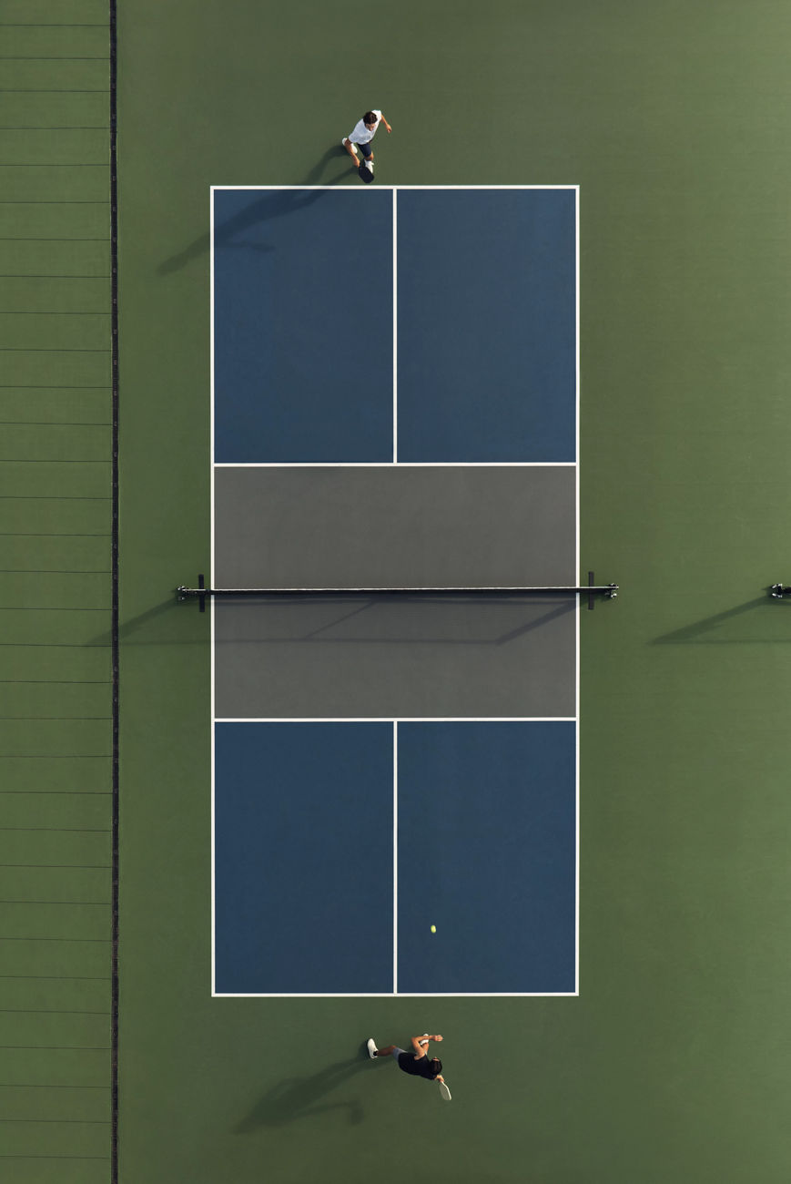 Aerial view of a doubles pickleball match on a Life Time court