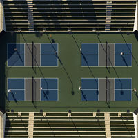 An aerial view of Life Time members playing on four outdoor pickleball courts