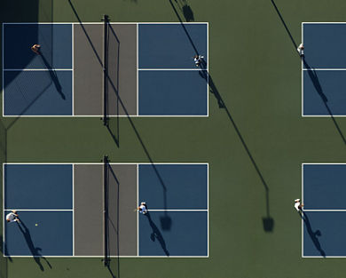 An aerial view of Life Time members playing on four outdoor pickleball courts