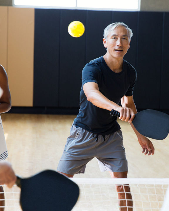 Active-agers playing a game of pickleball