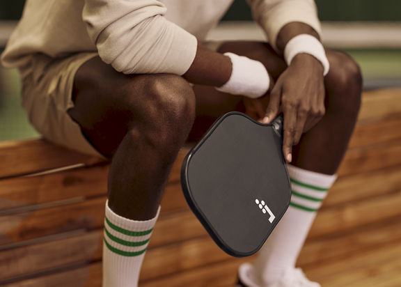 a man holding a pickleball racquet