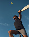 A pickleball player about to hit the ball