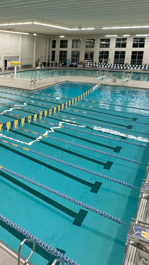 The indoor pool deck featuring lap pool and leisure pool at Life Time Plymouth