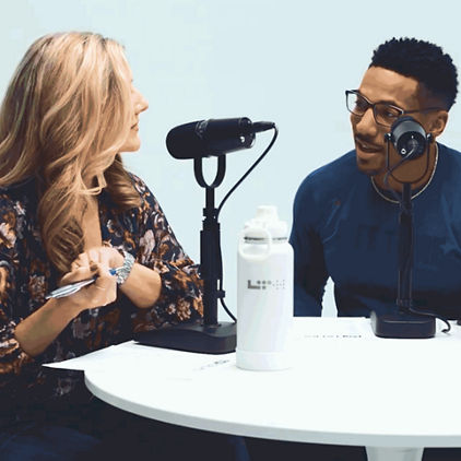 a man and a woman talking on a podcast