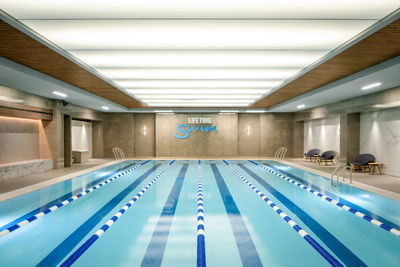 Indoor swimming pool featuring a blue ceiling, creating a serene and inviting atmosphere for swimmers.