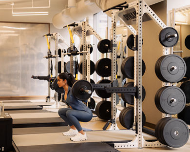 a woman lifting weights at Life Time
