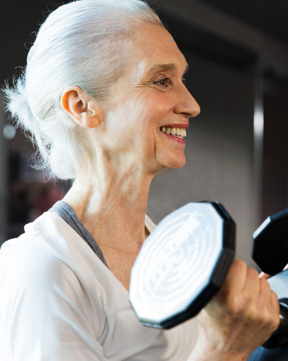 Female doing bicep curls during a personal training session.