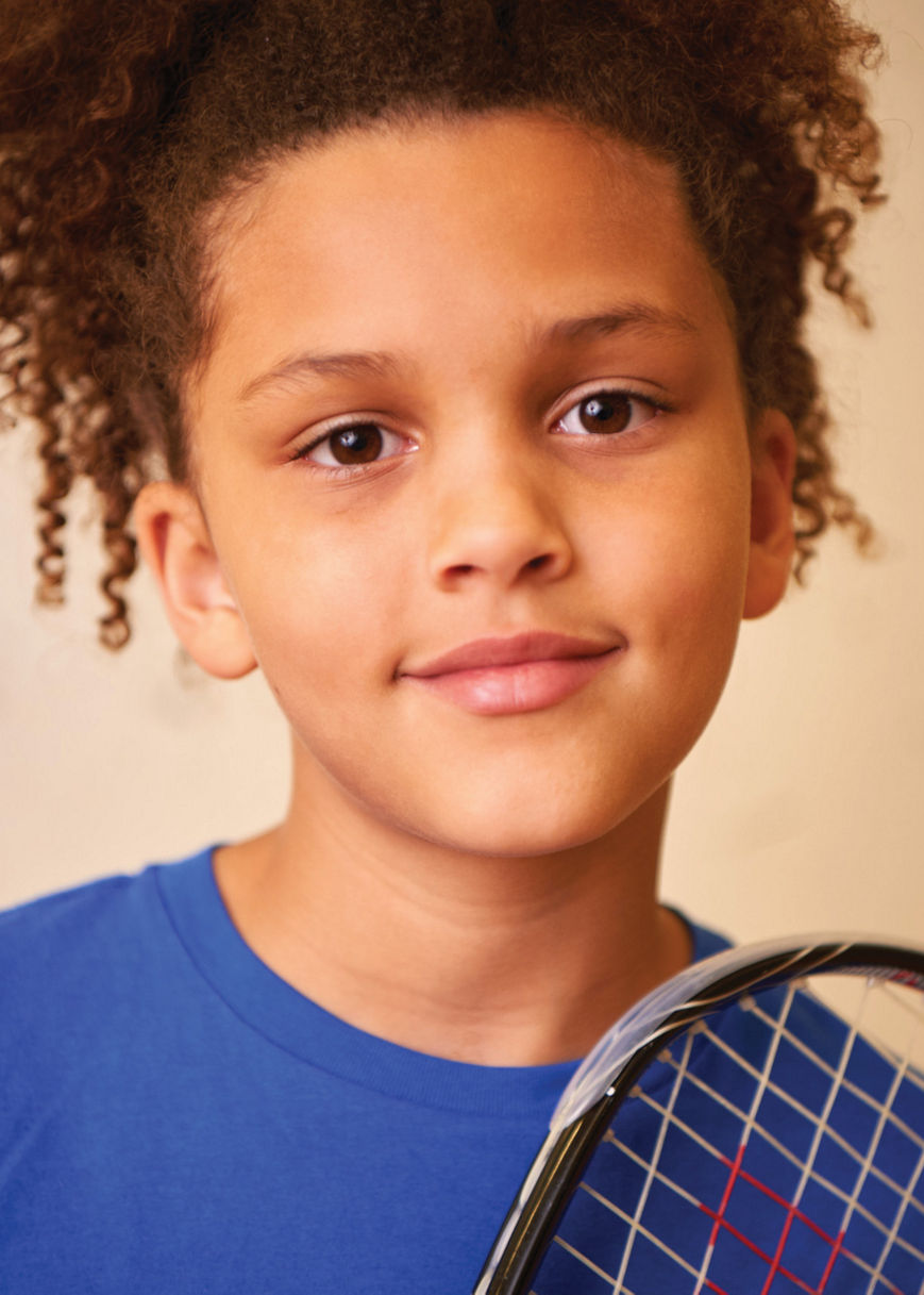 Close view of a child holding a racquetball racquet