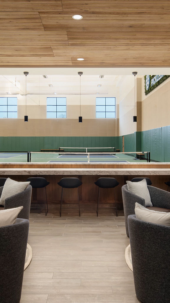 Open seating area next to indoor pickleball courts at Life Time