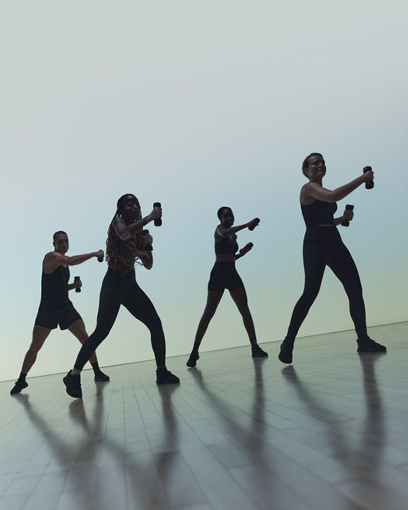 Remixx cardio dance class participants with hand weights in class at Life Time