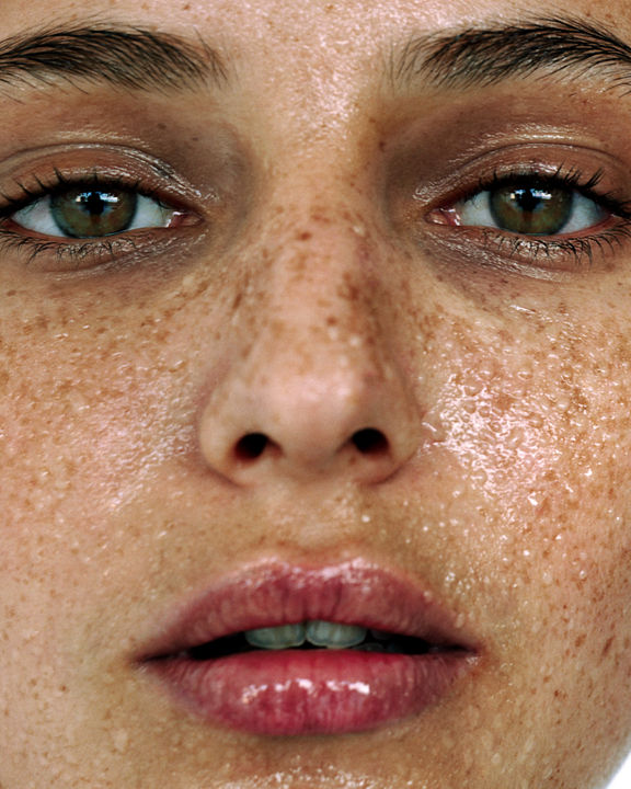 Closeup of a females face drenched with sweat