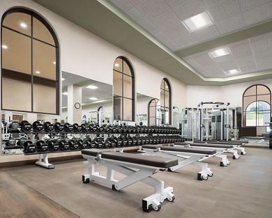 Weight benches and free weights located on the fitness floor in the Rancho San Clemente Life Time location.