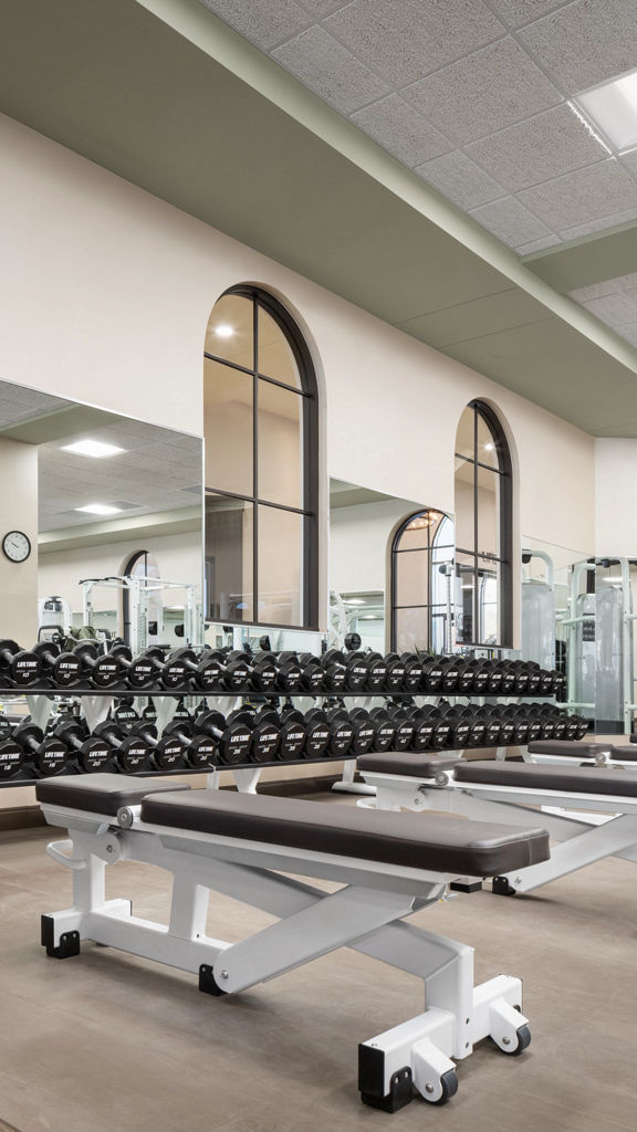 Weight benches and free weights located on the fitness floor in the Rancho San Clemente Life Time location.