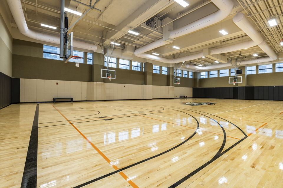 a large gymnasium with basketball hoops