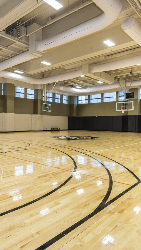 a large gymnasium with basketball hoops