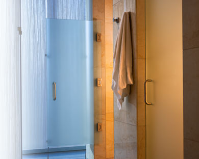 Glass and Tile shower stalls and hanging towel