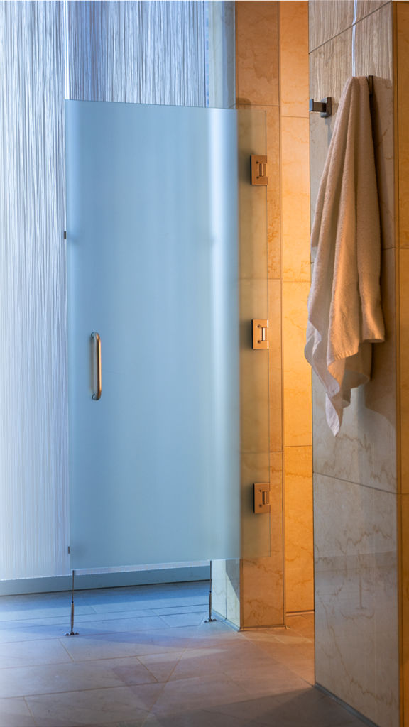 Glass and Tile shower stalls and hanging towel