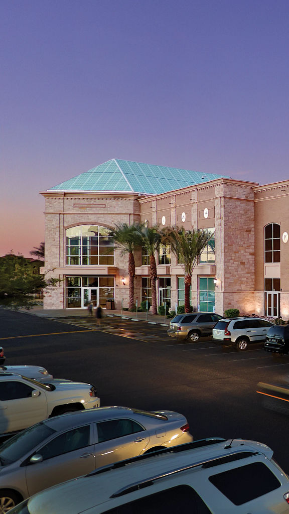 the exterior of a Life Time location with palm trees