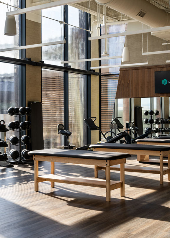 Stretch tables on the fitness floor at Life Time