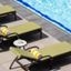 Lounge chairs uniformly positioned poolside at a Life Time outdoor pool