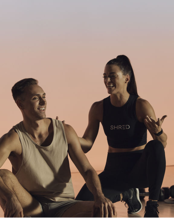 Instructor coaching a member during a Shred strength class