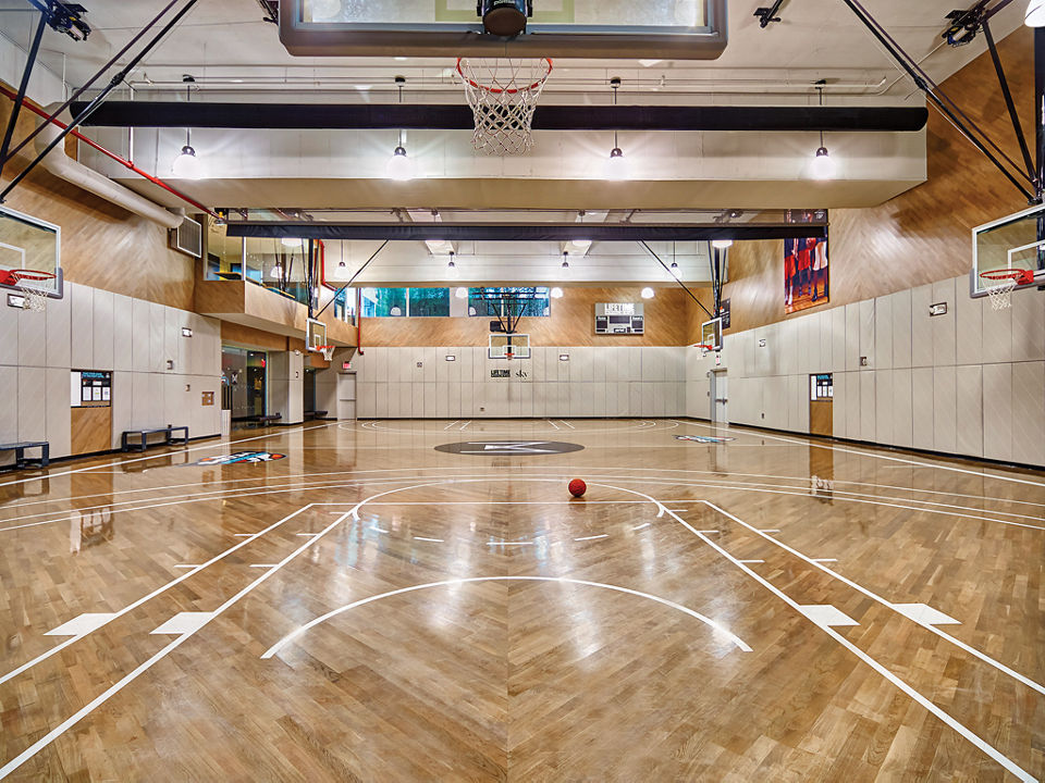 Brightly lit basketball court at the Life Time Sky club location