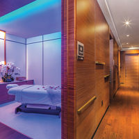 Hallway leading to an open massage room at the Life Time Sky club location