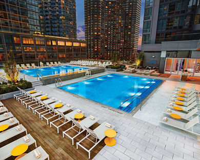 The rooftop pool deck at Life Time Sky at dusk