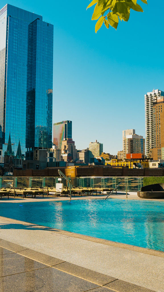 Beauty shot of the Life Time Sky club rooftop pool; New York City skyline in the background