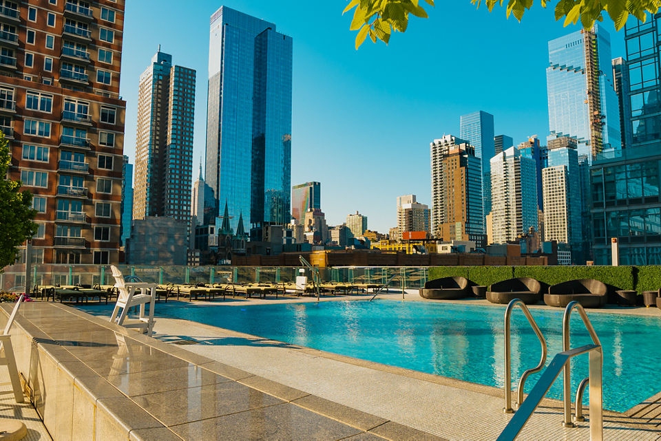 Beauty shot of the Life Time Sky club rooftop pool; New York City skyline in the background