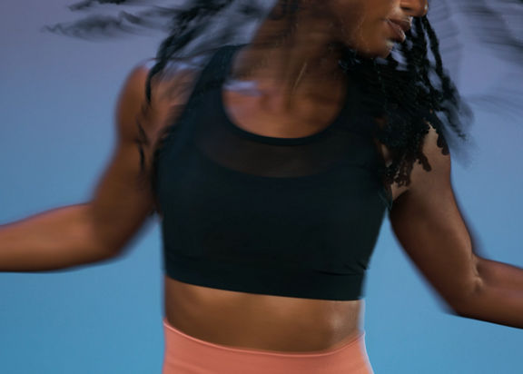 Close up of a Life Time member in motion during the sculpt portion of an AMP spin class
