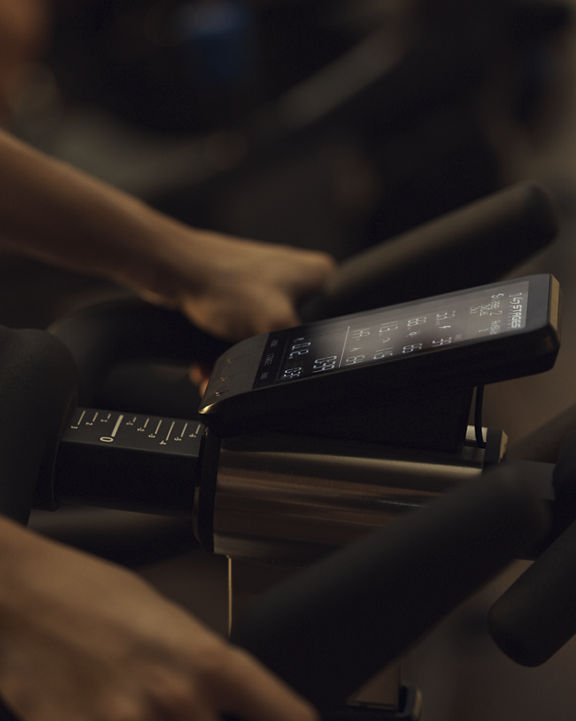 A close up of the output screen on a spin bike in a PWR cycle class at Life Time