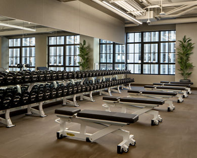 Weight benches and dumbbells on the fitness floor at the Life Time Stamford club location