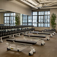 Weight benches and dumbbells on the fitness floor at the Life Time Stamford club location