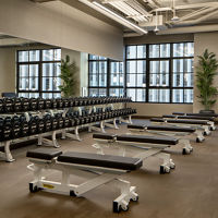 Weight benches and dumbbells on the fitness floor at the Life Time Stamford club location