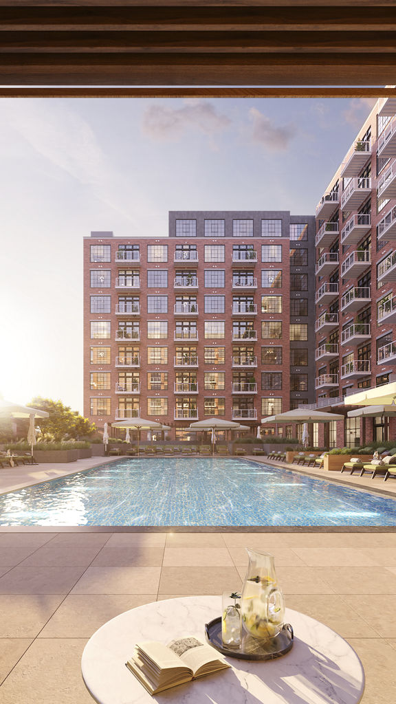 View of an outdoor pool shimmering in the sunlight from inside a cabana