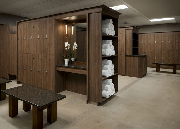 Locker bays with rolled white towels in the locker room at Life Time