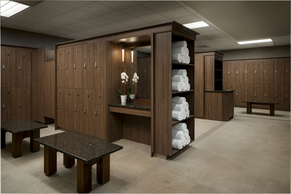 Locker bays with rolled white towels in the locker room at Life Time