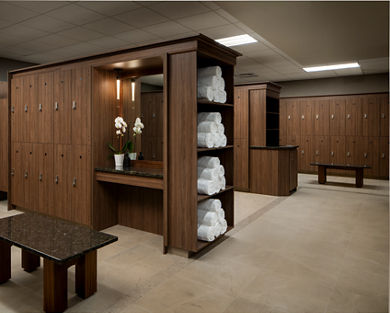 Locker bays with rolled white towels in the locker room at Life Time