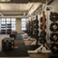 Alpha Studio filled with free weights at Life Time