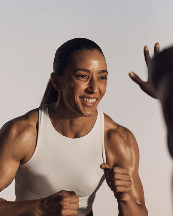 Smiling strike kickboxing martial arts class participant in ready stance at Life Time